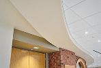 ULTIMA High-NRC Ceiling Panels / SUPRAFINE 9/16" Suspension System / Drywall Grid System / SimpleCurve trim / AXIOM Classic 6" Trim